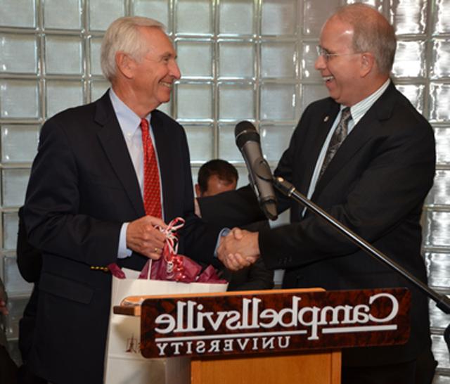 Dr. Michael V. Carter, president of Campbellsville University, presents a gift to Ky. Gov. Steve  Beshear during his visit to Campbellsville June 10.