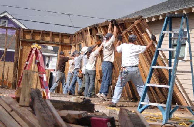 A group of Campbellsville University students helps tear down the wall of a home destroyed by Hurricane Katrina during a Spring Break mission trip to New Orleans. (Campbellsville University Photo by Rachel Crenshaw)